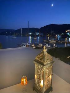 a lantern sitting on a table with a view of a harbor at Apanemo in Grikos