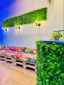 a couch covered in plants in a room at Hotel Alex Berlin in Berlin