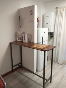 a wooden table in a room with a refrigerator at Loft Salto Chico in Concordia +81 photos