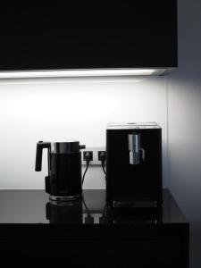a coffeemaker and coffee maker sitting on a counter at Apartman Grey in Prague