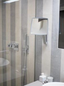 a bathroom with a toilet and a glass shower at Apartman Grey in Prague