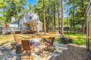 an outdoor patio with chairs and a house at The Chalet at Warren Dunes in Sawyer