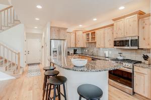 a kitchen with wooden cabinets and a counter with stools at Cobble Creek Pearl in Driggs