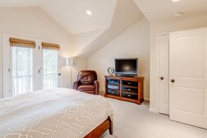 a bedroom with a bed and a tv and a chair at Cobble Creek Pearl in Driggs