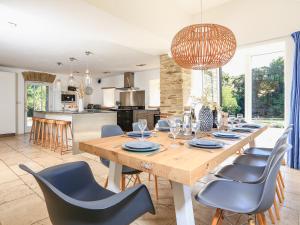 a kitchen and dining room with a wooden table and chairs at Linham Barn in Kingsbridge