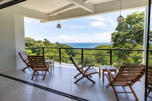 a balcony with chairs and a view of the ocean at Casa Paraíso - 3rd Floor in San Juan del Sur