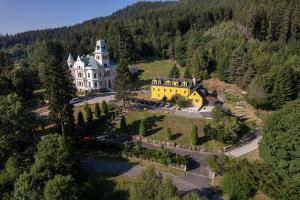 - une vue aérienne sur une grande maison dans les montagnes dans l'établissement Hotel U Zámečku Cihelny, à Karlovy Vary