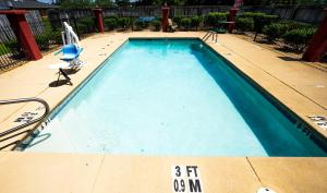 une grande piscine avec une chaise dans l'établissement Quality Inn & Suites, à Monroeville