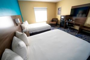 Cette chambre comprend deux lits et un bureau. dans l'établissement Quality Inn & Suites, à Monroeville