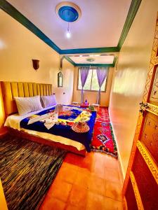 a bedroom with a bed and a table in it at Atlas Views in Imlil