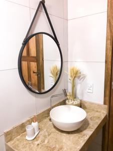 a bathroom with a sink and a mirror on a counter at Chalé Bela Vista in Tatajuba +53 photos
