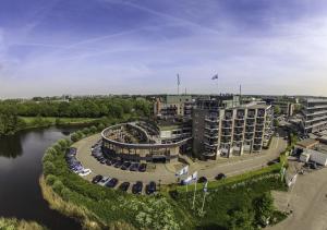 an aerial view of a building next to a river at Van der Valk Hotel Leusden - Amersfoort in Leusden