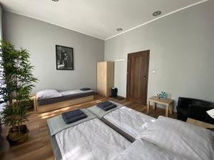 a bedroom with a bed and a couch in it at Hostel Rynek22 in Gliwice