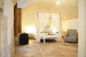 a bedroom with a bed and a chair in a room at Il Nido dei Falchi B&B in Altamura +56 photos