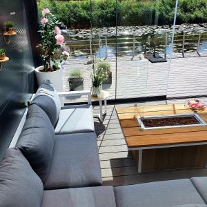 a living room with a couch and a table at B&B Apartment Amsterdam Schiphol Airport in Hoofddorp