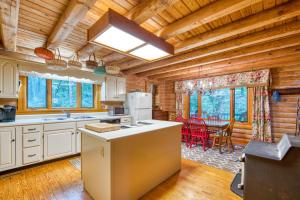 a kitchen with wooden ceilings and a dining room at Laurel Cabin in Cashiers