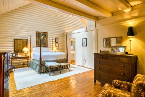 a bedroom with a bed and a dresser in a room at Laurel Cabin in Cashiers
