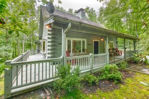 a tiny house with a porch and a deck at Laurel Cabin in Cashiers