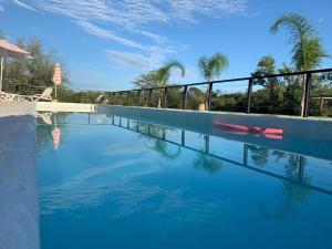 una piscina con agua azul y palmeras en El Descanso en Colón