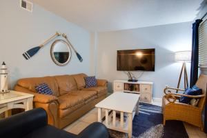 a living room with a couch and a tv at Beach side condo at Hilton Head Resort Villas in Hilton Head Island