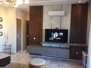 a living room with a flat screen tv on a wall at Rosa Park in Mohammedia