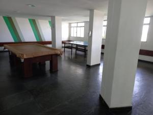 a room with a pool table and a ping pong table at Apartamento - CARIBE BRASILEIRO - Praia do Forte - De frente para o mar in Cabo Frio