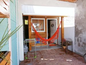 Tiny House moçambique - Sua casinha em Floripa! في فلوريانوبوليس: مدخل لبيت فيه أرجوحة في المدخل
