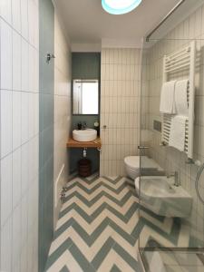a bathroom with a sink and a toilet at La Casa di Mina in Monte di Procida