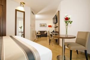 ein Hotelzimmer mit einem Bett und einem Tisch in der Unterkunft Residhome Paris-Massy in Massy