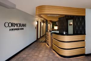 a lobby of a hotel with a reception counter at Cormorant Boutique Hotel in San Diego