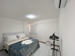 Rúm í herbergi á Apartamentos 250m da Orla -Edifício Nugali- Castelo B Temporada