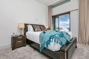 um quarto com uma cama grande e uma janela em Penthouse Premier em Auckland