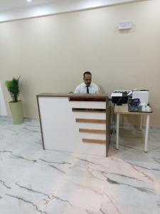 a man sitting at a desk in an office at MJI GROUP in Tan-Tan