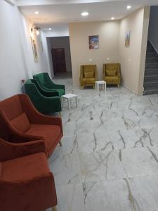 a lobby with couches and chairs on a marble floor at MJI GROUP in Tan-Tan