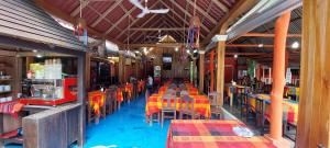 an empty restaurant with colorful tables and chairs in it at Cabañas Yax-ha in Arroyo Agua Azul