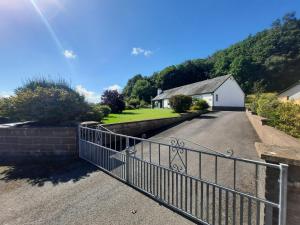 a driveway with a metal fence and a house at Dale View in Cockermouth