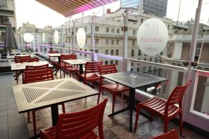 a balcony of a restaurant with tables and chairs at Hotel Sommelier Agustinas in Santiago