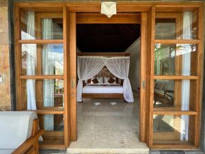 Postel nebo postele na pokoji v ubytování Danakha Villa Ubud