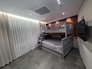 a bunk bed room with two bunk beds at House of gallery in Daegu