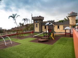 a playground in front of a house with a building at Laguna Park 2 in Adeje