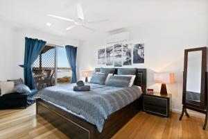 a bedroom with a large bed with blue curtains at Big Blue Tailem Bend in Tailem Bend