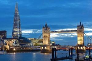 a bridge over the water with a city in the background at APlaceToStay Central London Apartment, Zone 1 in London +2 photos
