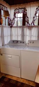 a kitchen with two stove tops and a window at Quiet upstairs studio close to town 420 friendly in Trinidad