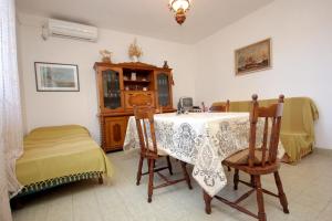 a dining room with a table and chairs and a room with at Apartments by the sea Vis - 8885 in Vis +15 photos