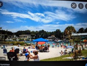 a group of people on a beach with a body of water at Private Residence Manatee Watch Den 3beds in Crystal River