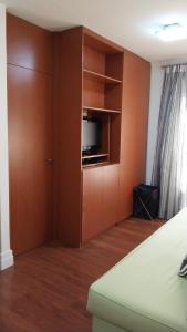 una sala de estar con TV en un armario en Flat em Hotel na Bela Cintra próximo à Paulista e Consolação en São Paulo
