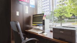 a desk with a computer and a printer on it at Hearton Hotel Higashi-Shinagawa in Tokyo