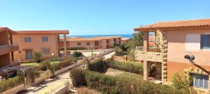 a view of a city with buildings and the ocean at Amazing Chalet North Coast Egypt in Dawwār ‘Abd Allāh