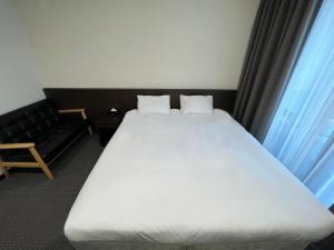 Postel nebo postele na pokoji v ubytování Incheon Rivieraverium Hotel