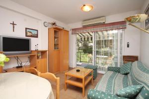 a living room with a couch and a tv at Apartments with a parking space Jelsa, Hvar - 8732 in Jelsa